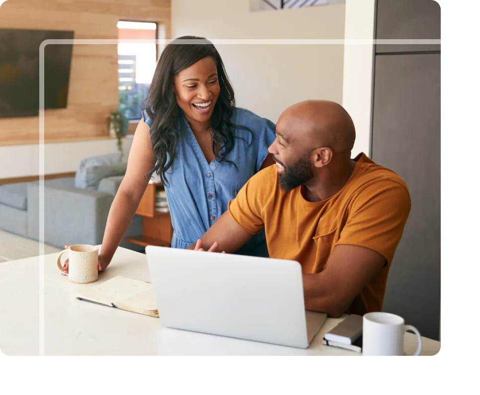 Man and women searching for local lawyers on a laptop at the kitchen counter.